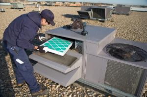 Apache Junction HVAC technician installs an air filter