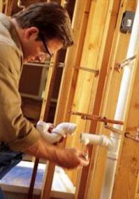professional Apache Junction plumber reseats an intake line on a Bradford White water heater